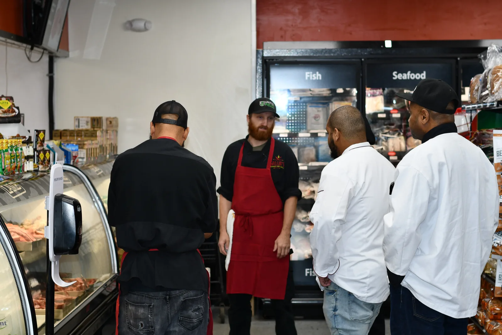 Operators in a food retail and processing environment discussing work flow