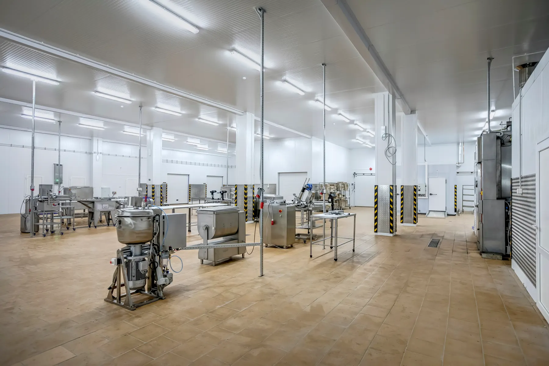 Hygienic meat processing room with stainless equipment and overhead rails